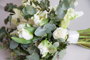 elegant stylish bridal bouquet wedding bouquet in white and green tones contains roses, orchids, eucalyptus branches