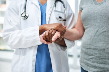 Doctor, holding hands and patient with empathy at hospital for medical diagnosis, treatment comfort...