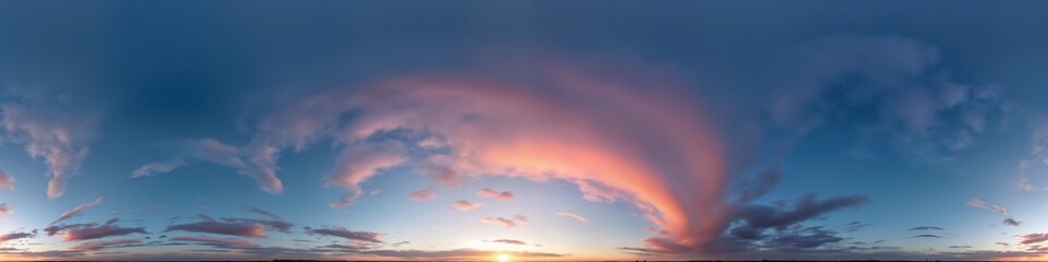 Fototapeta premium Stunning sunset panorama. Dark blue sky with soft pink cirrus clouds. Beautiful colors. Perfect for sky replacement in 3D visualizations or aerial drone photos. Evening twilight ambiance.
