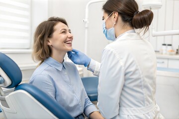 Obraz premium Young Woman Smiling at Dentist Appointment in Blue Striped Shirt