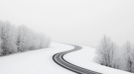 Obraz premium Winding snowy road, winter landscape, misty background, travel photography