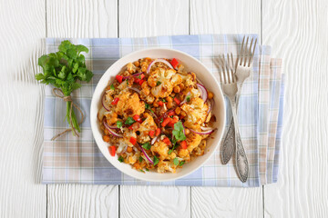 cauliflower chickpea quinoa salad in a white bowl