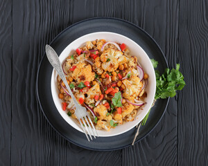 cauliflower chickpea quinoa salad in a white bowl