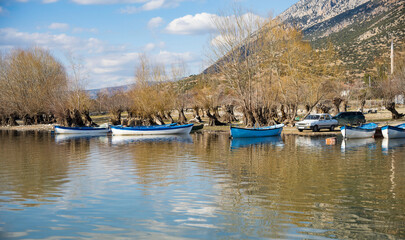 Fototapeta premium Decorated day-trip boats in Isikli Lake in Denizli's Civril district. Isıkli Lake is flooded with visitors during lotus time. It is also a popular lake for hunters.