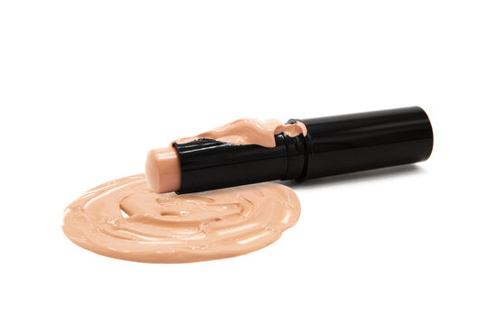 Concealer in package with dripping drops of foundation isolated on white background. Compact makeup foundation. Texture.