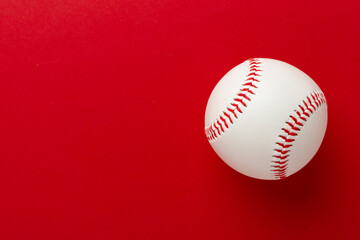 Baseball ball on color background, top view