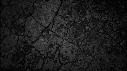 Close-up of a rough black rock surface with cracks and dirt, set against a dark background, ideal for a grunge design.