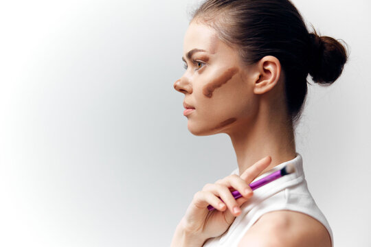 Beauty portrait of a woman with makeup technique showcasing contouring, soft lighting, and minimalist background ideal for beauty and skincare promotions.