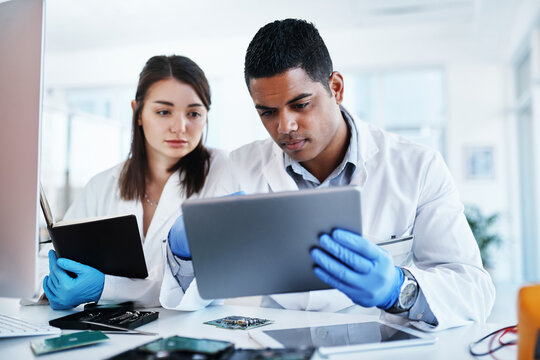Lab, engineer and people with tablet, serious and collaboration for project, electrical and repairing. Computer technology, teamwork and fixing of motherboard, maintenance and testing of system or IT