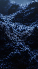 Dark ocean waves with frothy foam in deep blue lighting