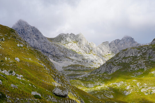 Rock mountain ridge and green valley of Prutas Peak trail