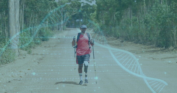 Hiking on dirt road, man with trekking poles over DNA strand image - Powered by Adobe