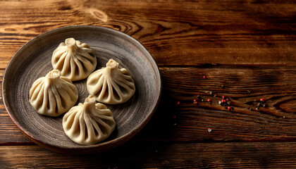 hot khinkali on a ceramic plate conventional georgian dumplings are served on a rustic timber desk