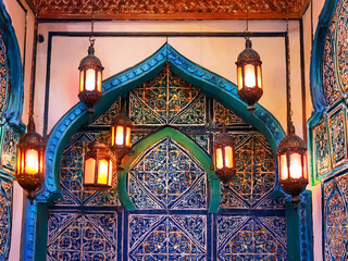 Colorful tile-inspired Islamic pattern with lanterns at corners