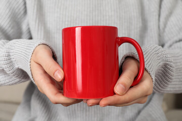 Woman with red ceramic cup, closeup. Mockup for design