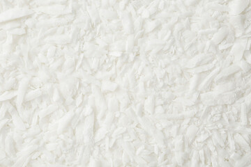 White soy wax flakes as background, closeup