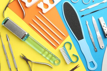 Set of pedicure tools on color background, flat lay
