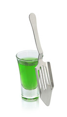Absinthe in shot glass and slotted spoon isolated on white
