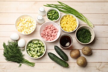 Different ingredients for okroshka soup on white wooden table, flat lay