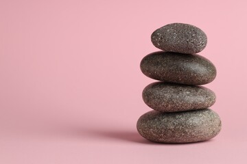 Stack of rocks on pink background. Harmony and life balance