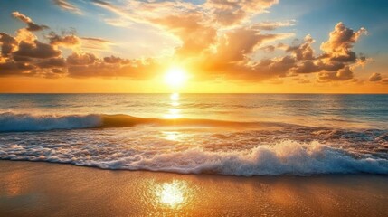 Obraz premium A golden sun setting over the ocean, casting warm light across gentle waves as clouds drift lazily in the peaceful sky.