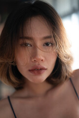 Asian model portrait in bedroom studio.