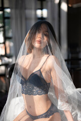 Asian model portrait in bedroom studio.