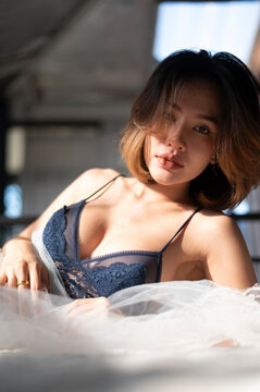 Asian model portrait in bedroom studio.