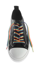 Black shoe with bright rainbow lace on white background, above view. LGBT concept