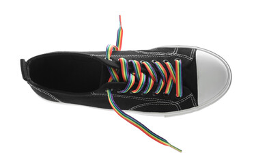 Black shoe with bright rainbow lace on white background, top view. LGBT concept