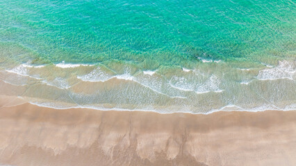 panoramic drone view of waves crashing on beach