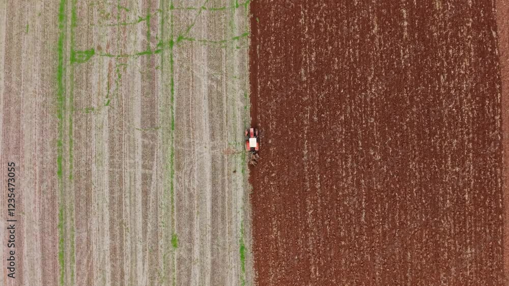 Poster a top-down view of a tractor from above as it plows the field