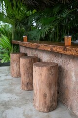 Fototapeta premium Wooden stools at an outdoor bar with tropical drinks