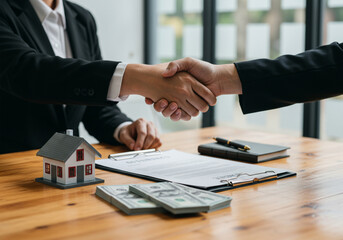 Professional handshake in a real estate transaction, symbolizing agreement on property investment and sales.