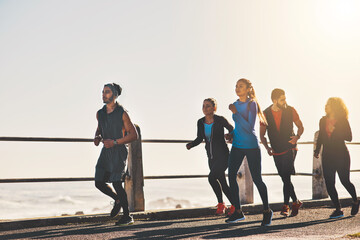 People, fitness and running with sunshine by beach for cardio workout, exercise or training...