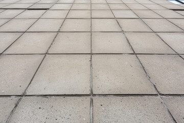 A gray tiled floor with a few cracks