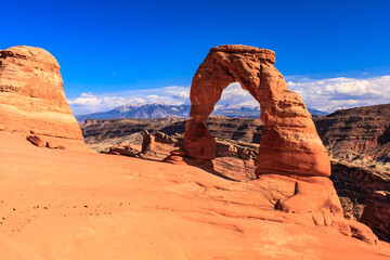 The desert landscape is full of rocks and the sky is blue
