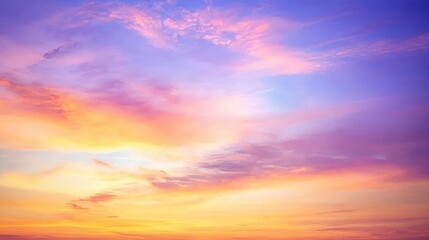 Obraz premium Vibrant Sunset Sky with Soft Clouds and Colorful Hues at Dusk