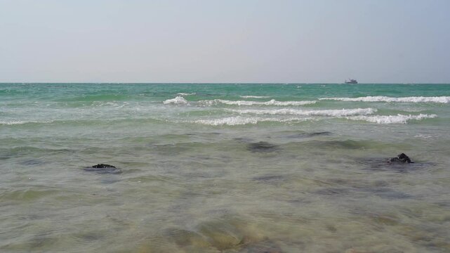 seascape landscape background by sea beach or island with clear water little waves and nature rocks stone to ship marine or boat for summer holiday travel at Sai Kaew Beach in Thailand in slow motion