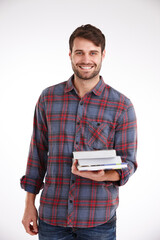 Man, student and happy with books in studio portrait with pride, education or learning by white background. Person, smile and scholarship for college, development and studying for test in Australia