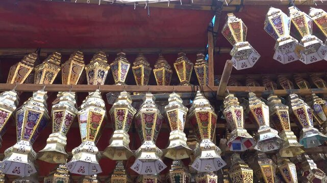 Cairo, Egypt A panning view of lanterns in the Khan Al-Khalili bazaar and the Al Azhar Mosque and minaret. 