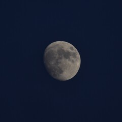 Close up of a beautiful near full moon in front of a dark sky