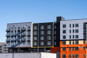 New multistory mixed use commercial and residential building under construction on a sunny winter...