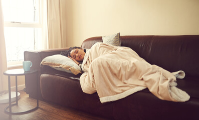 Relax, sleep and woman on sofa with blanket, fatigue and calm morning rest in living room at home....