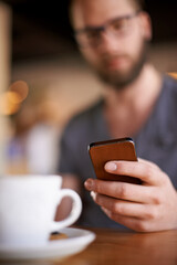 Hand, phone and man in coffee shop on internet, typing text or 5 star review closeup. Cafe table, mobile and chat notification, communication or influencer post drink on social media profile online