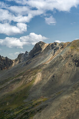 Scenic Mountain Ridge Under Clear Blue Sky and Fluffy Clouds