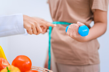 Female Asian nutritionist providing consultations for weight loss. reduce belly fat, offering advice on nutrients, metabolism, hydration, balanced diets to improve overall health and wellness.