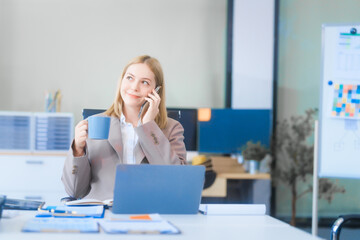 A young Russian woman in formal suit works diligently in business office, analyzing financial...