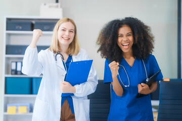 Young African American and Russian woman, both scientists, collaborate to analyze blood samples,...