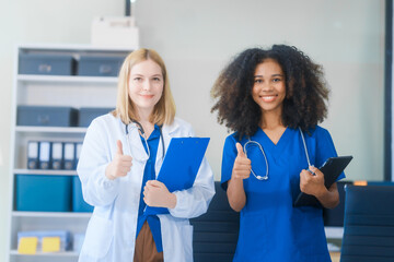 Young African American and Russian woman, both scientists, collaborate to analyze blood samples,...